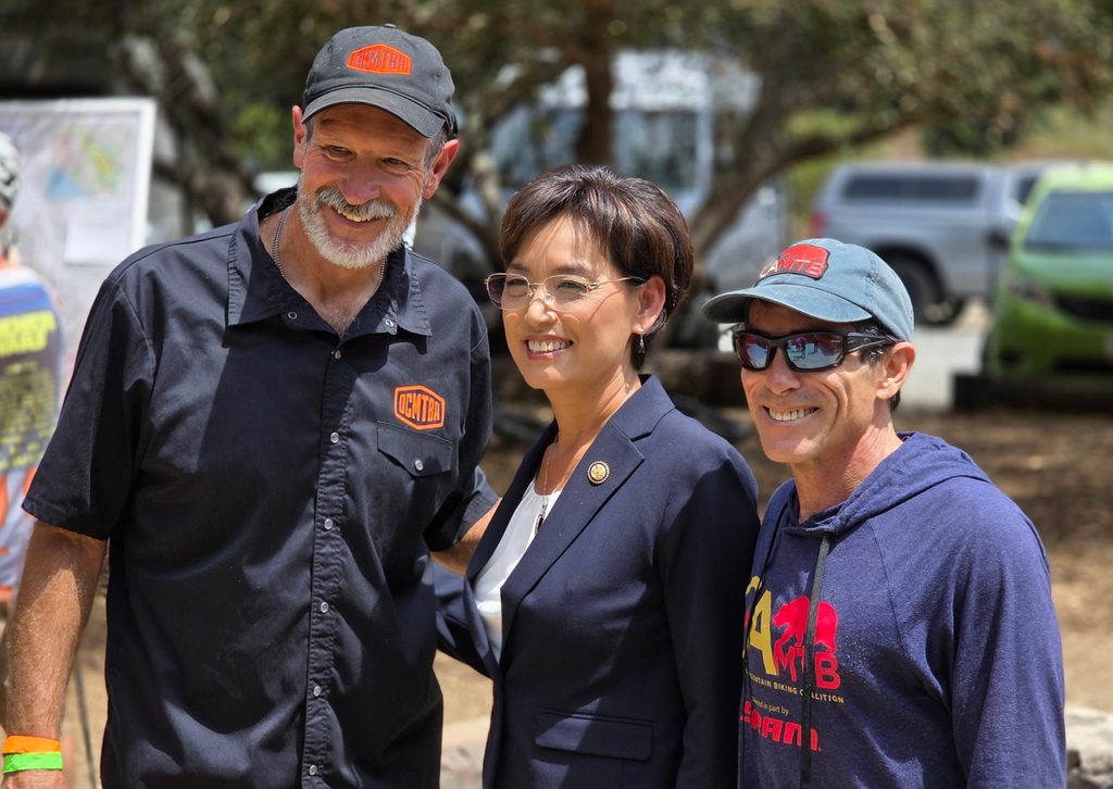 OCMTBA President David Browning and CAMTB Board President Steve Messer standing with Representative Young Kim at the OC Trail Festival.
